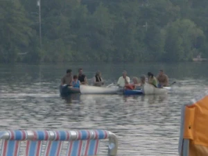 Spotlight: Browns Mills - Lakes, Land & Livability 4 Canoes on the lake during a winter festival in Browns Mills, New Jersey with community members gathered along the shore