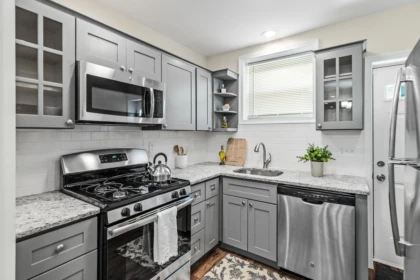 Kitchen with gray painted cabinets and glass doors in a Browns Mills home