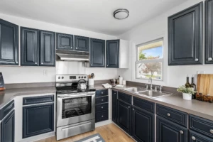 Before You Spend $20K: 5 Kitchen Updates That Actually Work 4 Kitchen with dark painted cabinets in a Pemberton home