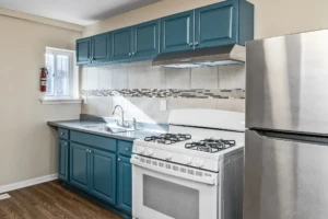 Before You Spend $20K: 5 Kitchen Updates That Actually Work 2 Kitchen with teal painted cabinets in a Burlington City home