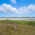 Wooden bench overlooking the Delaware River in Palmyra, New Jersey.