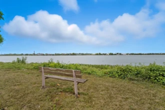 Wooden bench overlooking the Delaware River in Palmyra, New Jersey.