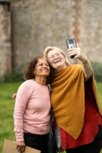 International Women’s Day: Celebrating Progress and Possibility 2 Two women smiling while taking a selfie together outdoors