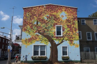 Colorful mural on building wall in downtown Mount Holly NJ featuring a tree design and public art streetscape