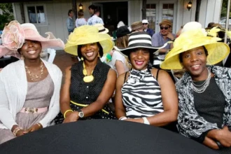 Women enjoying an outdoor brunch with mom wearing hats on Mother’s Day