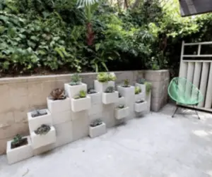 Earth Day at Home: 8 Smart Ways to Reuse Everyday Items 5 Cinder block wall used as a planter with small plants