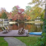 Lakefront deck and Adirondack chairs overlooking a Medford Lakes NJ waterfront in autumn
