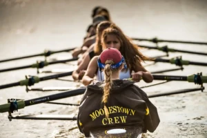 Moorestown crew team practicing rowing on the water