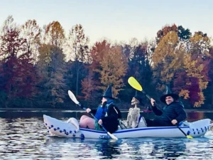 Kayakers in witch costumes participating in the Medford Lakes Lions Club Witches Paddle event.